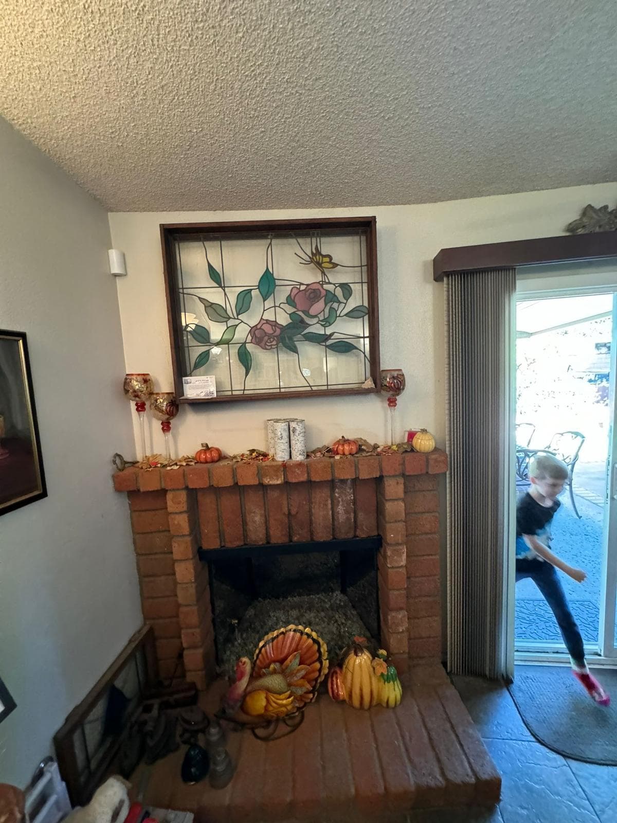 Living room fireplace before insert installation and remodel showing original brick firebox and surround