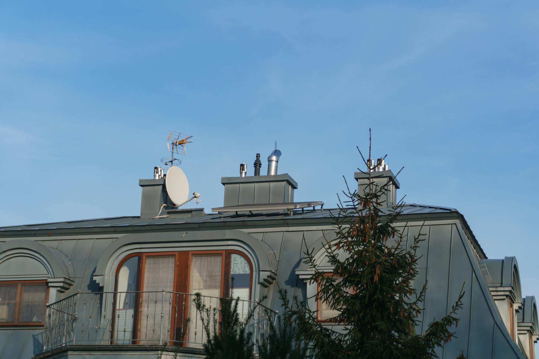 Metal chimney chase cover on residential rooftop